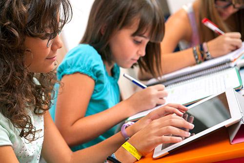 School children learning on Tablets